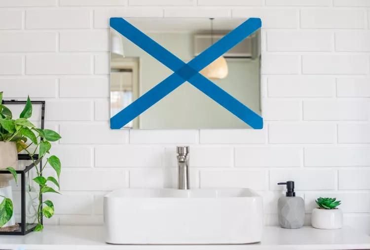 putting painter's tape on to the mirror